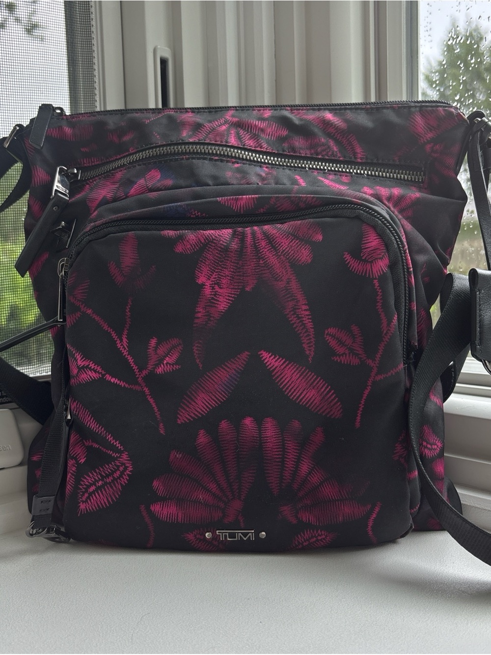 Tumi Black Voyager Crossbody Bag with Magenta Floral Pattern
